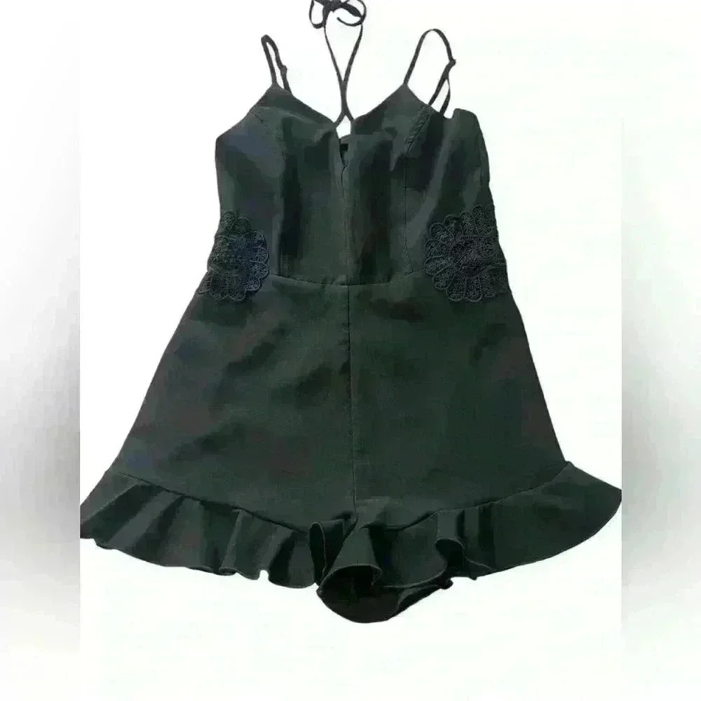 Black Romper Embroidered floral design , ruffle hem, zip up adjustable straps